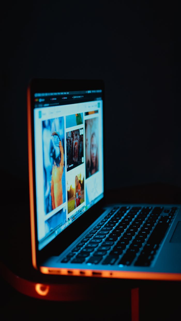 ours-journey A laptop screen showing pictures in a dimly lit room, highlighting digital era browsing.