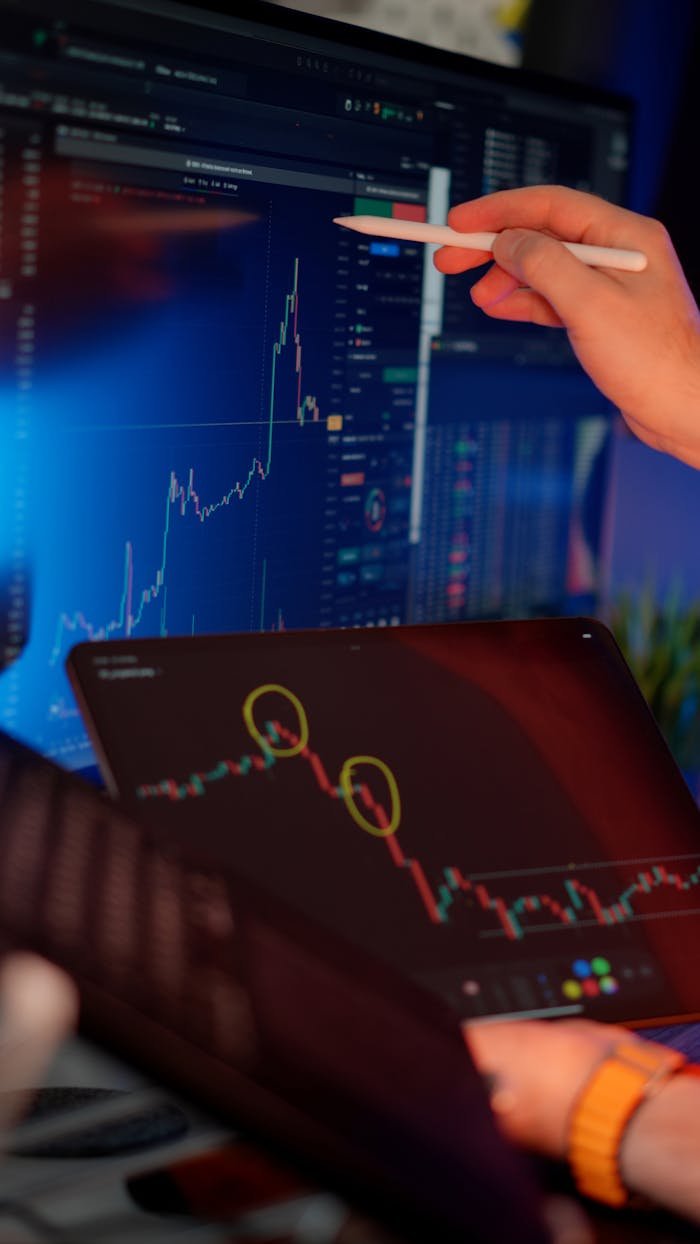 services-img A person analyzes cryptocurrency market trends on multiple screens with graphs.